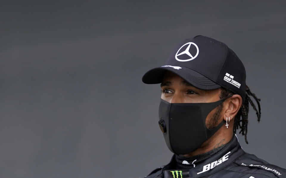 Mercedes driver Lewis Hamilton of Britain addresses the media after he clocked the fastest time during the qualifying session for the British Formula One Grand Prix at the Silverstone racetrack, Silverstone, England, Saturday, Aug. 1, 2020. The British Formula One Grand Prix will be held on Sunday. (Will Oliver/Pool via AP)