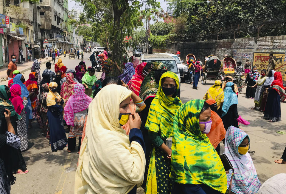 Bangladeshi garment workers block a road demanding their unpaid wages during a protest in Dhaka, Bangladesh, Thursday, April 16, 2020. Hundreds of Bangladeshi workers who produce garments for global brands protested in Dhaka and blocked a highway outside the capital on Thursday to demand unpaid wages during a nationwide lockdown that has forced most factories to suspend operations. (AP Photo/Al-emrun Garjon)