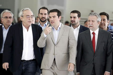 Greek Prime Minister Alexis Tsipras (C) gestures as he is escorted by Minister for Culture, Education and Religious Affairs Aristides Baltas (2nd L), Deputy Minister for Culture, Education and Religious Affairs Stavros Kontonis (R) and government spokesman Gabriel Sakellaridis (rear, 2nd R) during his visit at the ministry in Athens June 2, 2015. REUTERS/Alkis Konstantinidis