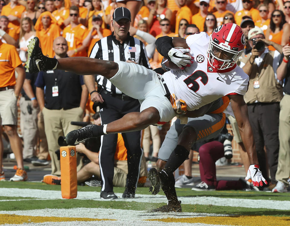 Georgia wide receiver Javon Wims catches a touchdown pass over Tennessee defensive back Shaq Wiggins during the first half an <a href="https://sports.yahoo.com/college-football/" data-ylk="slk:NCAA college football;elm:context_link;itc:0;sec:content-canvas" class="link ">NCAA college football</a> game against Tennessee on Saturday, Sept. 30, 2017, in Knoxville, Tenn. (Curtis Compton/Atlanta Journal-Constitution via AP)