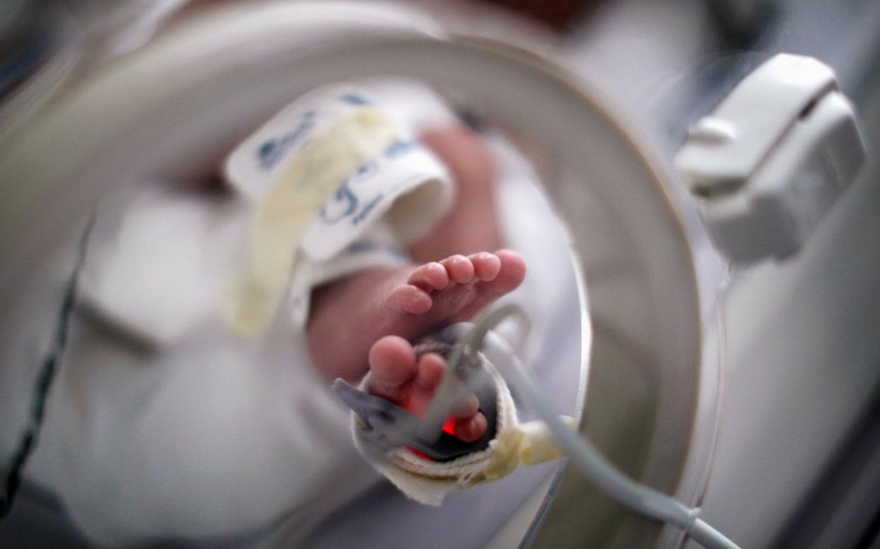 the feet of a newborn baby - REUTERS