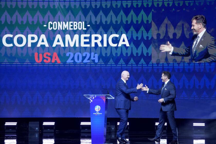 CONMEBOL President Alejandro Dominguez, right, greets FIFA President Gianni Infantino.