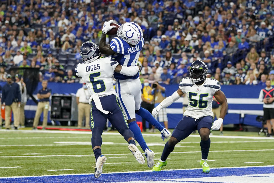 Indianapolis Colts wide receiver Zach Pascal (14) makes catch between Seattle Seahawks strong safety Quandre Diggs (6) and linebacker Jordyn Brooks (56) for a touchdown in the first half of an NFL football game in Indianapolis, Sunday, Sept. 12, 2021. (AP Photo/Charlie Neibergall)