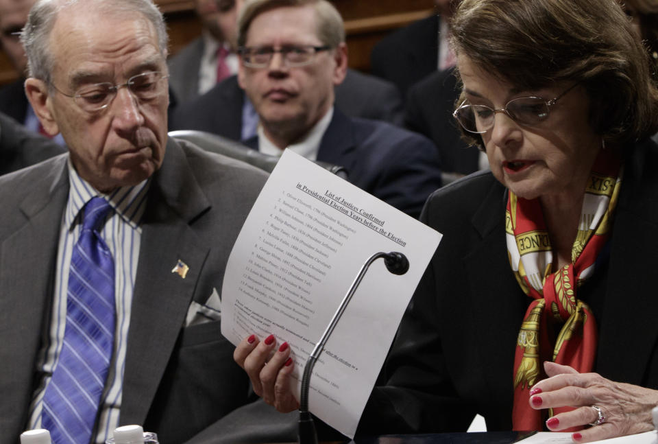 Senate Judiciary Committee Chairman Sen. Charles Grassley, R-Iowa, center, listens as the committee's ranking member, Sen. Dianne Feinstein, D-Calif. requests a one week postponement for the panel to vote on Supreme Court nominee Neil Gorsuch, as she displays a list of appointments made during presidential election years, Monday, March 27, 2017, on Capitol Hill in Washington. (AP Photo/J. Scott Applewhite)