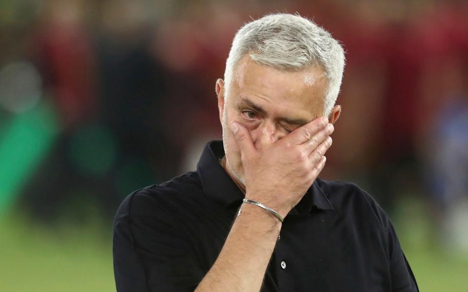 Roma's head coach Jose Mourinho wipes his eyes after winning the Europa Conference League final - AP