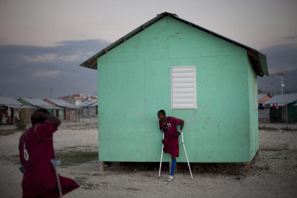 In this picture taken on Feb.17, 2012, amputees, some whose limbs were amputated due to an injuries suffered in the 2010 earthquake, play soccer at La Piste in Port-au-Prince, Haiti. While more than a million people displaced by the 2010 quake ended up in post-apocalyptic-like tent cities, some of the homeless people with disabilities landed in the near-model community of La Piste, a settlement of plywood shelters along tidy gravel lanes. However, the rare respite for the estimated 500-plus people living at the camp is coming to an end as the government moves to reclaim the land. (AP Photo/Ramon Espinosa)