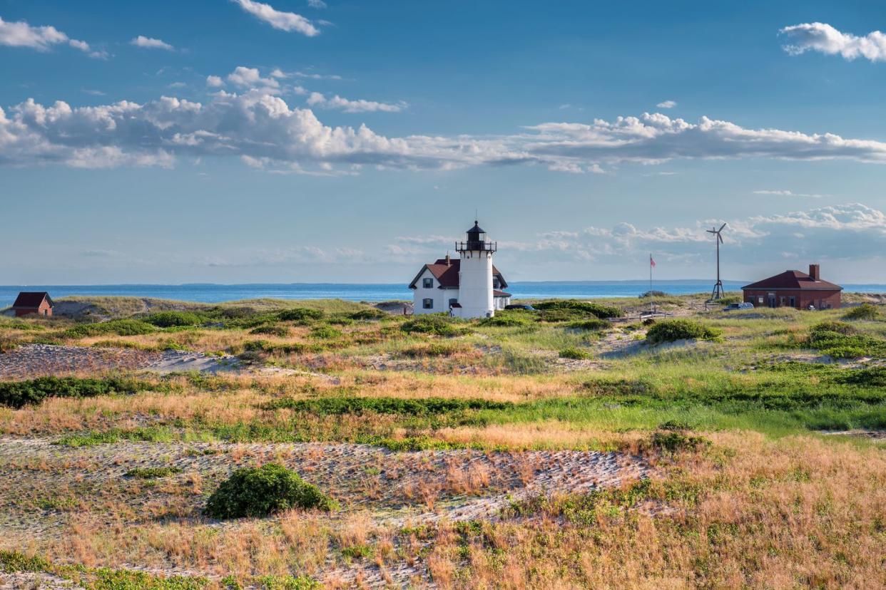 lighthouse on sand dunes in cape cod beach