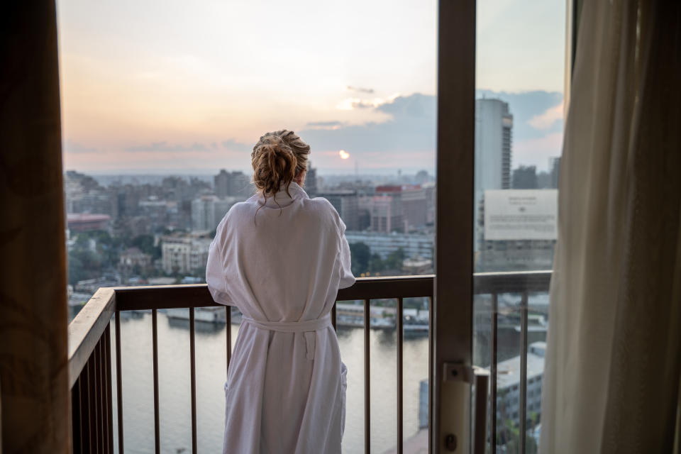 Woman enjoys sunset by the Nile river, Egypt