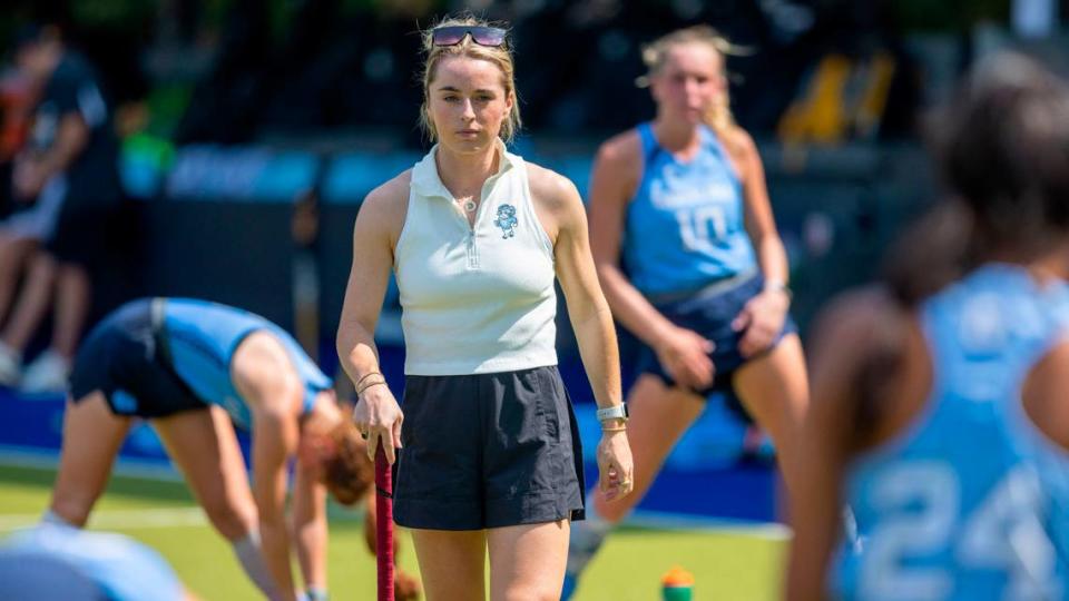 North Carolina field hockey coach Erin Matson walks amongst her players as they stretch prior to their overtime period against Iowa on Sunday, August 27, 2023 at Karen Shelton Stadium in Chapel Hill, N.C.