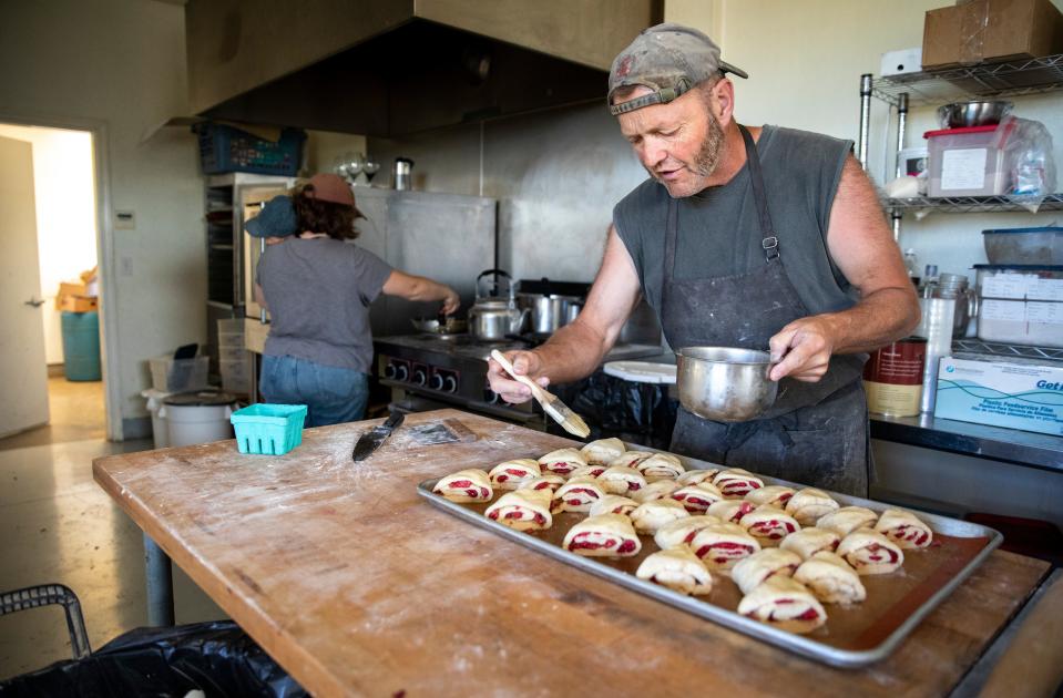 Raymond Fordyce prepares raspberry scones before the farm opens for the day in Salem. Fordyce has perfected the recipe and knows it by heart.