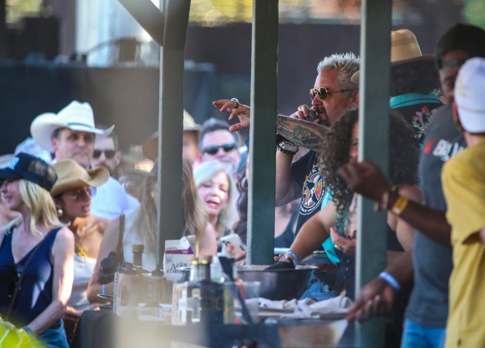 Guy Fieri leads a cooking demonstration with Hardy and Bailey Zimmerman at Guy Fieri's Smokehouse during Stagecoach country music festival in Indio, Calif., Sunday, April 28, 2024.