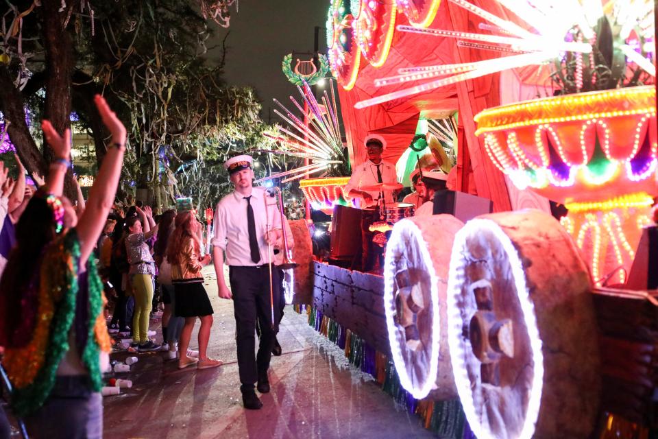 Revelers cheer as the Krewe of Orpheus rolls through New Orleans the night before Mardi Gras, known as Lundi Gras, Monday, Feb. 20, 2023.