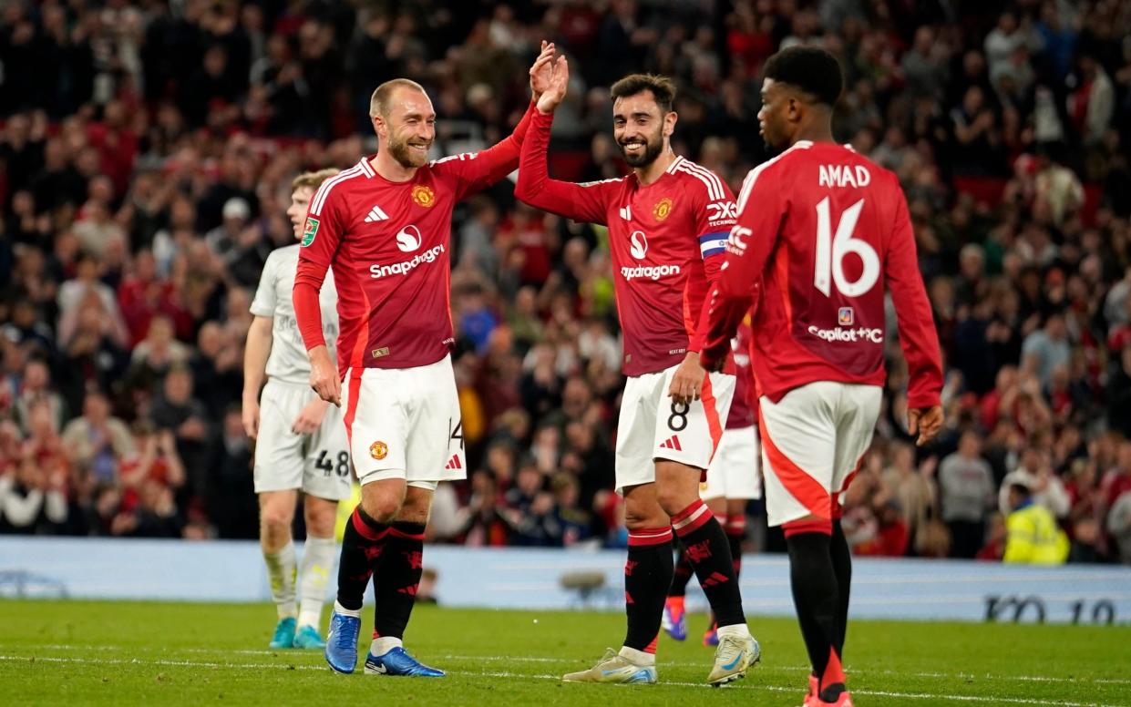 Manchester United's Christian Eriksen celebrates with Manchester United's Bruno Fernandes