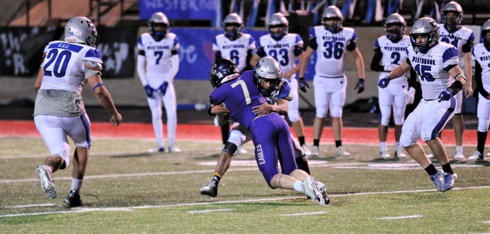 Westbrook's Cedric Ware tackles Sterling City's Carter Glass after a catch to force a turnover on downs on the Eagles' final offensive play of the game as teammates Jimmy Roberts (20) and Hadley White (15) look on. The stop preserved a 44-41 Westbrook victory in the Class 1A Division II state quarterfinal game Friday, Nov. 26, 2021 at Colorado City's Wolf Stadium.