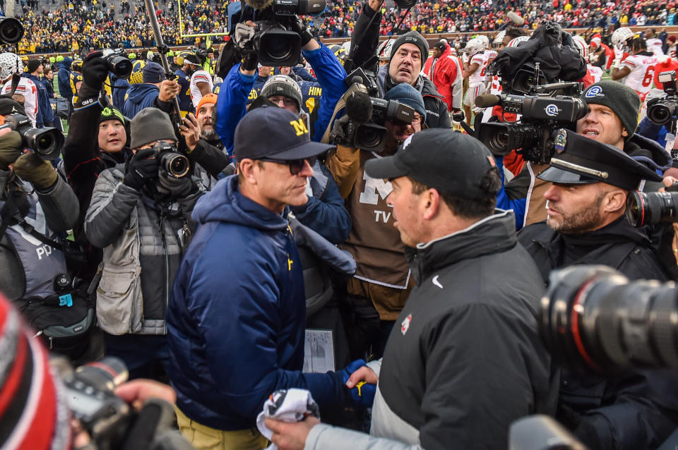 ANN ARBOR, MICHIGAN - NOVEMBER 30: Head Coach Ryan Day (R) of the Ohio State Buckeyes shakes hands with Head Coach Jim Harbaugh (L) of the Michigan Wolverines after a college football game at Michigan Stadium on November 30, 2019 in Ann Arbor, MI. The Ohio State Buckeyes won the game 56-27 over the Michigan Wolverines. (Photo by Aaron J. Thornton/Getty Images)