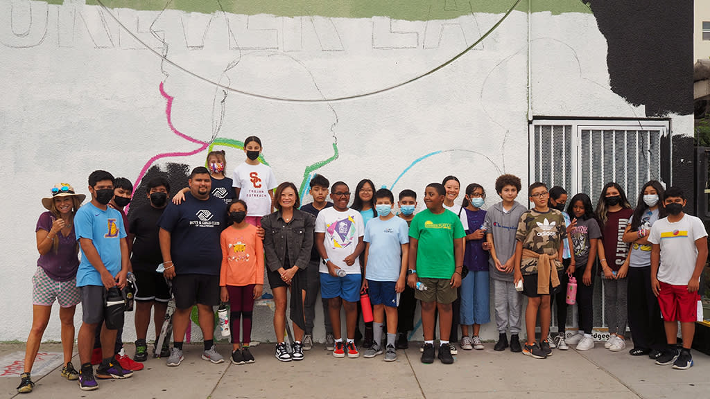 Forever 21 CEO Winnie Park (center left) and a group of local children get ready to paint a mural in Los Angeles. - Credit: Forever 21