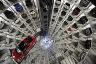 A Volkswagen "Beetle" (L) and an "UP!" are pictured in a delivery tower at the company's headquarter in Wolfsburg, Germany March 12, 2012.