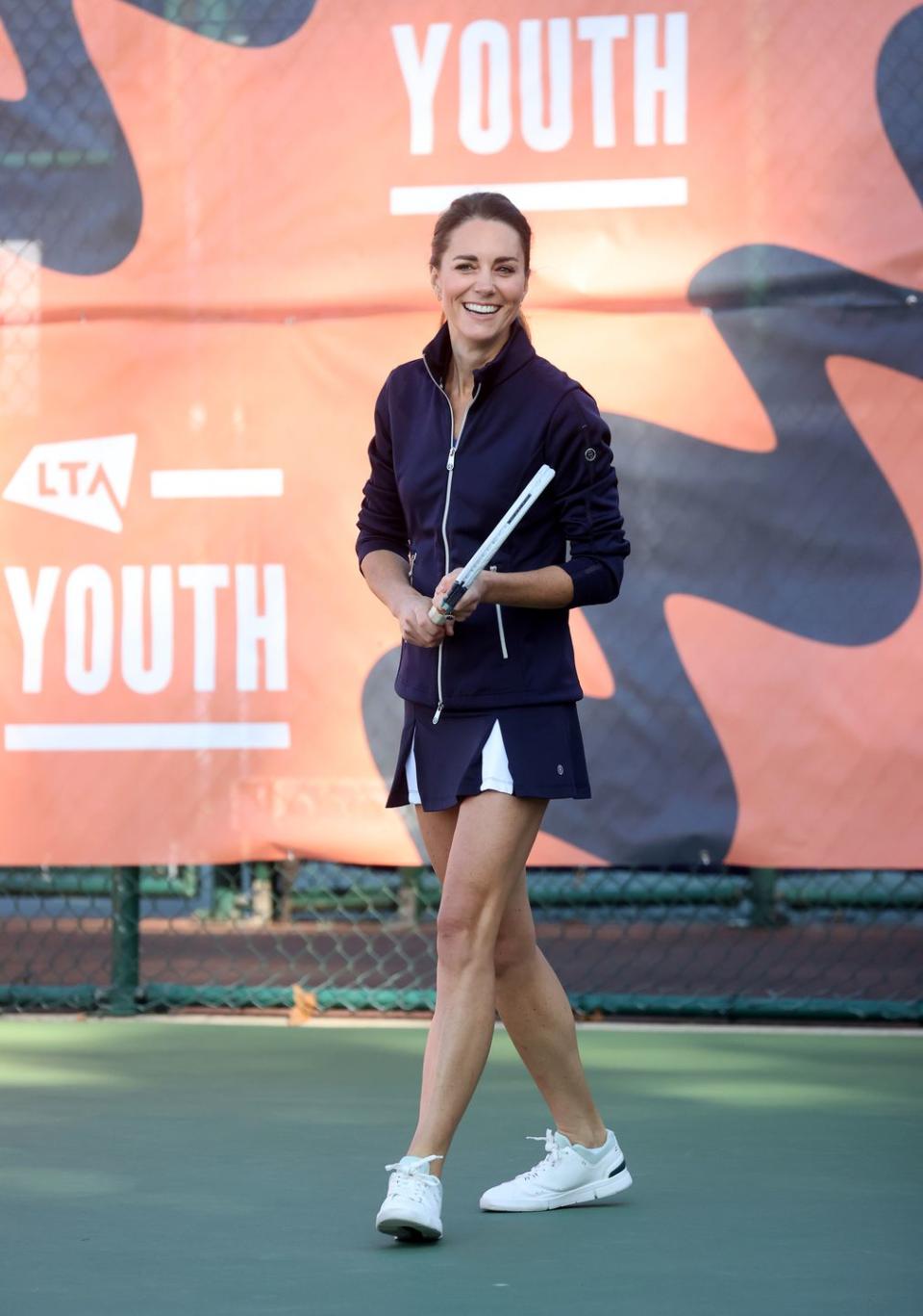 <p>In case there was any doubt about the stylishness of the <a href="https://www.townandcountrymag.com/style/g37374577/best-tennis-outfits/" rel="nofollow noopener" target="_blank" data-ylk="slk:tennis fashion trend;elm:context_link;itc:0;sec:content-canvas" class="link ">tennis fashion trend</a>, Kate donned a perfectly put-together navy blue tennis skirt with contrasting white panels, a navy and white jacket, and <a href="https://www.townandcountrymag.com/style/g28073171/best-white-sneakers-for-women/" rel="nofollow noopener" target="_blank" data-ylk="slk:white sneakers;elm:context_link;itc:0;sec:content-canvas" class="link ">white sneakers</a> for a <a href="https://www.townandcountrymag.com/society/tradition/a37721234/kate-middleton-plays-tennis-with-us-open-champion-emma-raducanu-photos/" rel="nofollow noopener" target="_blank" data-ylk="slk:doubles match with US Open Champion Emma Raducanu;elm:context_link;itc:0;sec:content-canvas" class="link ">doubles match with US Open Champion Emma Raducanu</a>. </p>