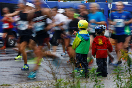 Athletics - Berlin Marathon - Berlin, Germany - September 24, 2017 Runners run past children during the race REUTERS/Hannibal Hanschke