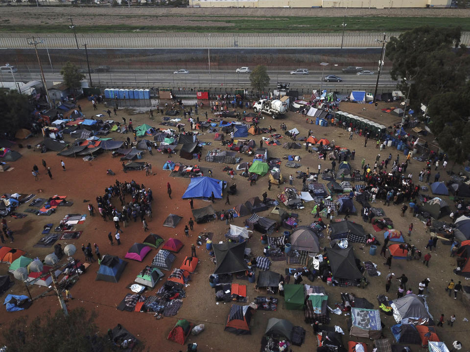 Central American migrants gather at a temporary shelter, near barriers that separate Mexico and the United States, in Tijuana, Mexico, Wednesday, Nov. 21, 2018. “I feel for the migrants who are arriving from other countries just like we did,” said Haitian immigrant Philocles Julda. “But you do adapt.” And work is plentiful in Tijuana, whose economy has been growing and whose factories have thousands of openings. (AP Photo/Rodrigo Abd)