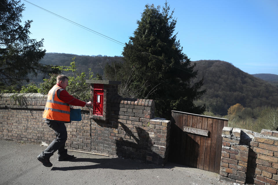 Postal delivery worker Matt delivers mail in the village of Ironbridge in Shropshire, while his customers have to stay at home, after Prime Minister Boris Johnson has put the UK in lockdown to help curb the spread of the coronavirus.