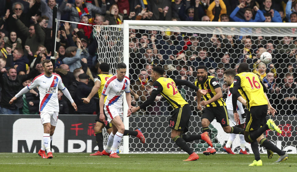 Watford's Etienne Capoue, centre, celebrates scoring his side's first goal of the game, during the FA Cup quarter final soccer match between Watford and Crystal Palace , at Vicarage Road, in Watford, England, Saturday March 16, 2019. (Jonathan Brady/PA via AP)