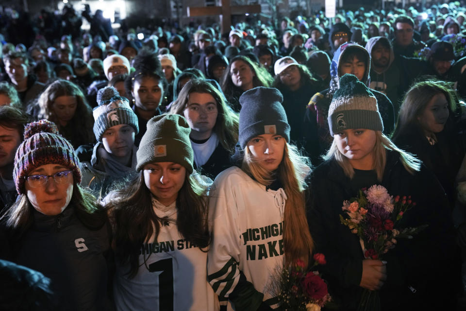 Mourners attend a vigil at The Rock on the grounds of Michigan State University in East Lansing, Mich., Wednesday, Feb. 15, 2023. Alexandria Verner, Brian Fraser and Arielle Anderson were killed and several other students remain in critical condition after a gunman opened fire on the campus of Michigan State University Monday night. (AP Photo/Paul Sancya)