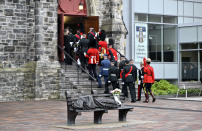 <p>Flowers rest on a sculpture depicting Jesus as a homeless person, by Canadian sculptor Timothy Schmalz, is seen as the guard of honour carrying Her Majesty's Personal Canadian Flag marches into Christ Church Cathedral for the National Commemorative Ceremony in honour of Queen Elizabeth, in Ottawa, on Monday, Sept. 19, 2022. (THE CANADIAN PRESS/Justin Tang)</p> 