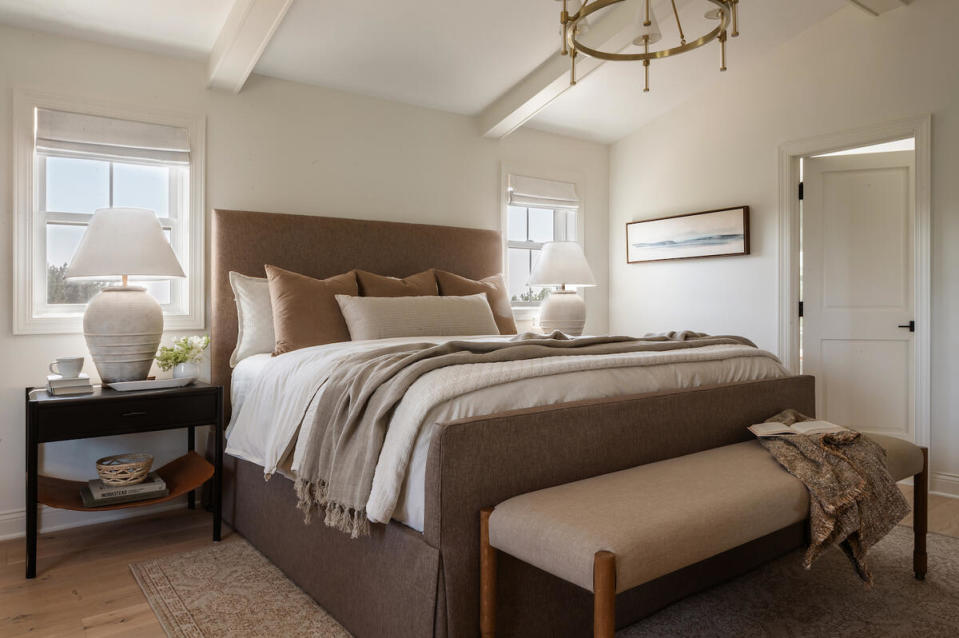 A chocolate upholstered bed warms up this bedroom