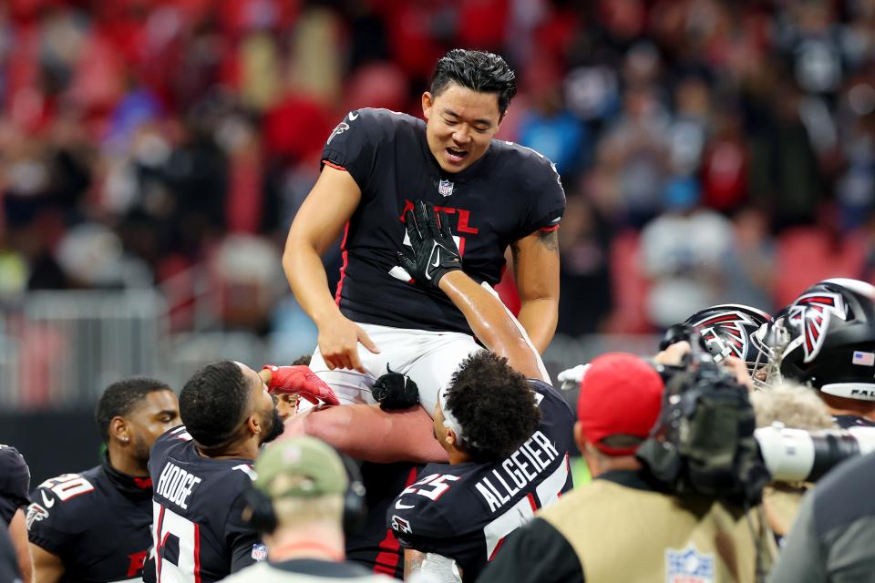 Falcons kicker Younghoe Koo is carried off the field after making the game-winning overtime field goal against the Carolina Panthers at Mercedes-Benz Stadium.