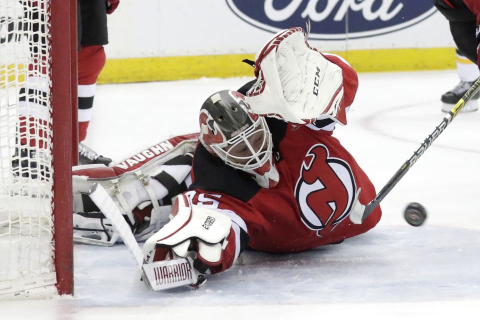 <p>
              New Jersey Devils goaltender Cory Schneider tries to stop a scoring shot by Boston Bruins center Patrice Bergeron during the first period of an NHL hockey game Thursday, March 21, 2019, in Newark, N.J. (AP Photo/Julio Cortez)
            </p>