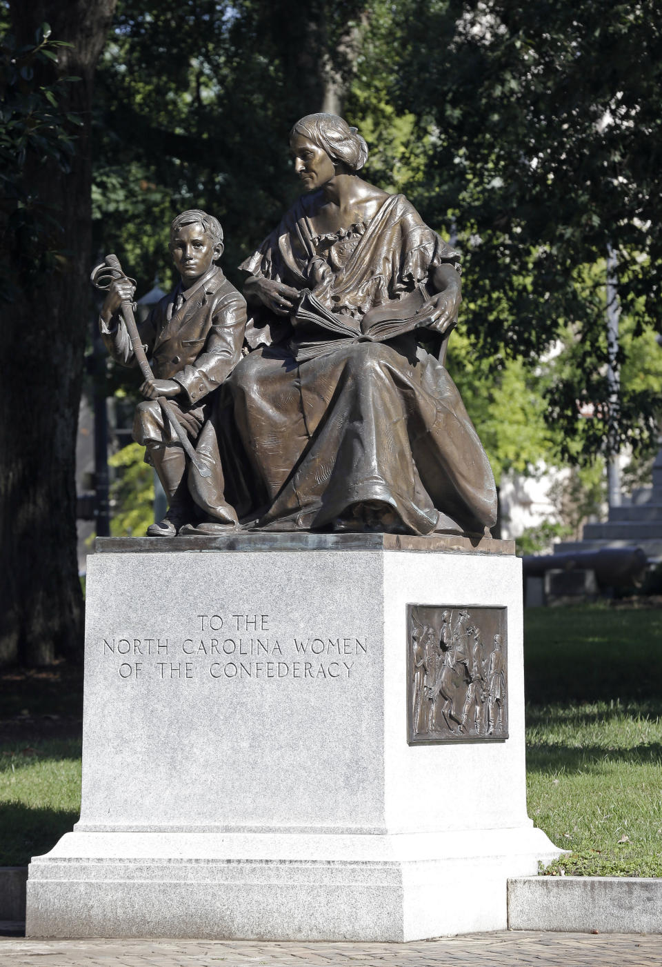 FILE - This Sept. 19, 2017, file photo shows a monument recognizing the North Carolina women of the Confederacy at the state Capitol in Raleigh, N.C. A North Carolina historical commission decided Wednesday, Aug. 22, 2018, that this Confederate monument and two others should remain on the state Capitol grounds with newly added context about slavery, weighing in less than two days after another rebel statue was torn down by protesters at the state’s flagship university. (AP Photo/Gerry Broome, File)