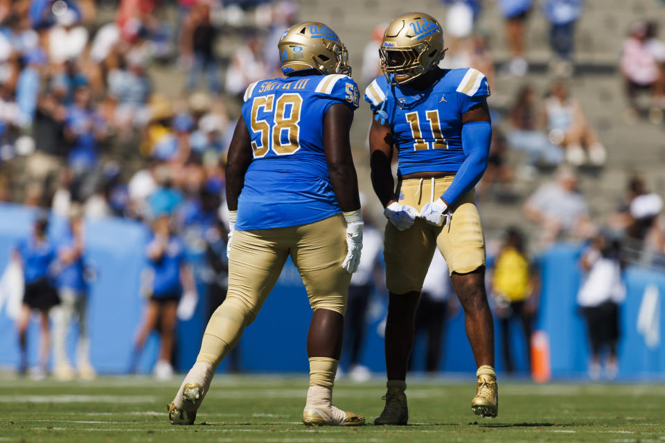 PASADENA, CA - OCTOBER 07: UCLA Bruins defensive lineman Gary Smith III (58) and UCLA Bruins defensive lineman Gabriel Murphy (11) celebrate during the college football game against the Washington State Cougars on October 7, 2023 at Rose Bowl Stadium in Pasadena, CA. (Photo by Ric Tapia/Icon Sportswire via Getty Images)