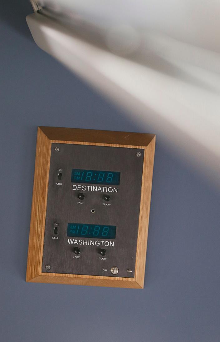 A clock with Washington and destination time zones on Air Force Two