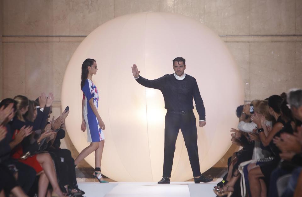 French fashion designer Roland Mouret waves after the presentation of his ready-to-wear Spring/Summer 2014 fashion collection, in Paris, Friday, Sept.27, 2013. (AP Photo/Thibault Camus)