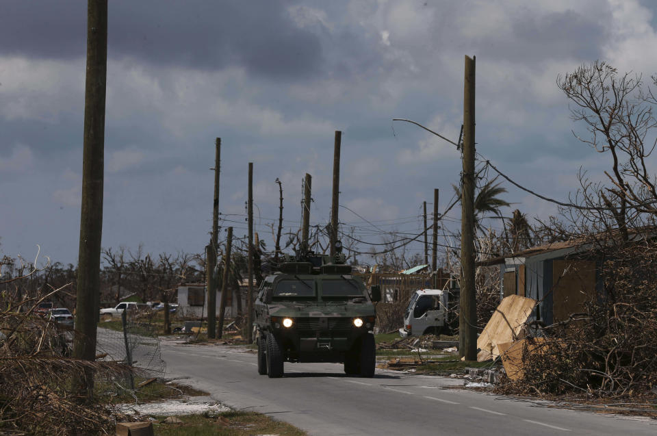 A Bahamian Army armored vehicle drives past a devastated landscape in the aftermath of Hurricane Dorian, in Marsh Harbor, Abaco Island, Bahamas, Saturday, Sept. 7, 2019. Search and rescue teams were still trying to reach some Bahamian communities isolated by floodwaters and debris Saturday after Dorian struck the northern part of the archipelago last Sunday. (AP Photo/Fernando Llano)