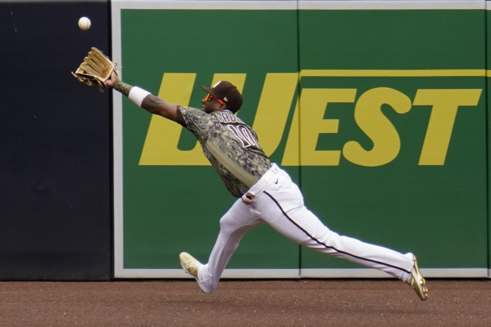 San Diego Padres left fielder Jurickson Profar makes the catch for the out on San Francisco Giants' Mike Tauchman during the first inning of a baseball game Sunday, May 2, 2021, in San Diego. (AP Photo/Gregory Bull)