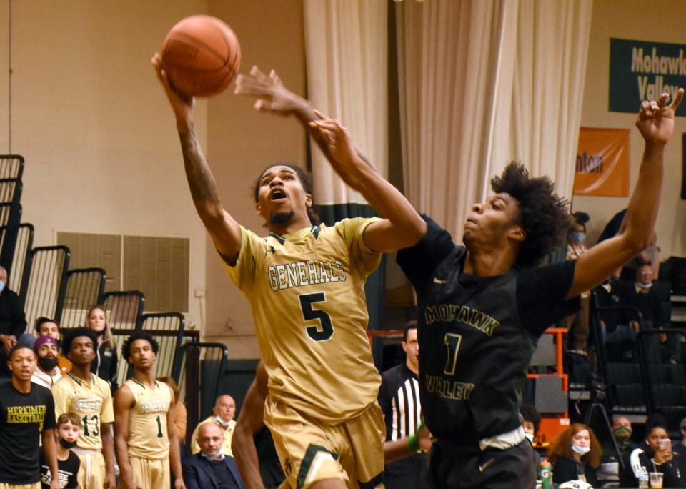 Herkimer College General Keyshawn Miller (5) attempts a shot in the second half Sunday with Travis Gray (1) defending for Mohawk Valley Community College.