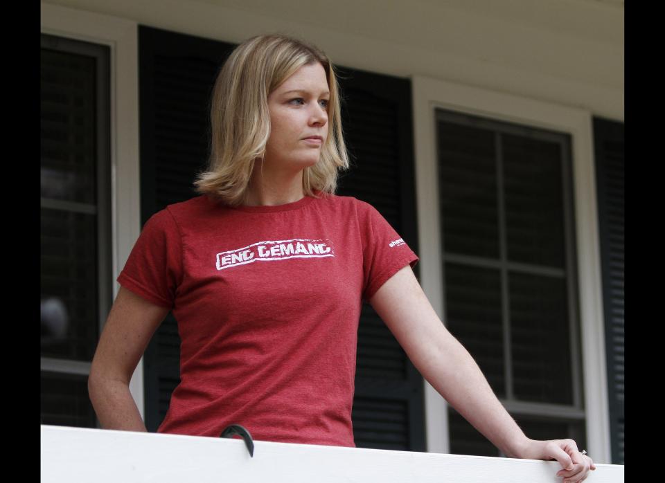 In this Tuesday, Nov. 22, 2011 photo, Holly Smith, 33, looks out form her porch after talking about her experiences when she was caught up in a child sex trafficking ring during an interview in her home in Richmond, Va. A new report says 41 states have failed to adopt strong penalties against human trafficking, and advocates say a patchwork of differing state laws makes it difficult for authorities to target the crime. Smith said a man at a mall promised her a job after she ran away from home at age 14. She said she was swiftly brought to a motel where two adults gave her a dress, put makeup on her face and dyed her hair. 