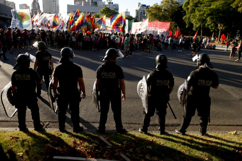 Police face demonstrators protesting U.S. intervention in Venezuela, outside the U.S embassy in Buenos Aires, Argentina, Monday, Feb. 18, 2019. The U.S. has used military and civilian aircraft to fly in food and personal care aid to Venezuela's Colombian border, in an effort meant to undermine Venezuelan President Nicolas Maduro and dramatize his government's inability to overcome shortages of food and medicine. (AP Photo/Natacha Pisarenko)