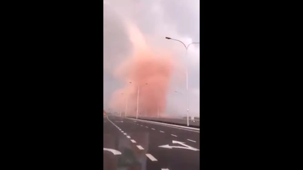 The under one minute clip shows a motorist driving through a rosy hued dust devil in Pengerang. — Screengrab via Facebook/We Are Malaysians