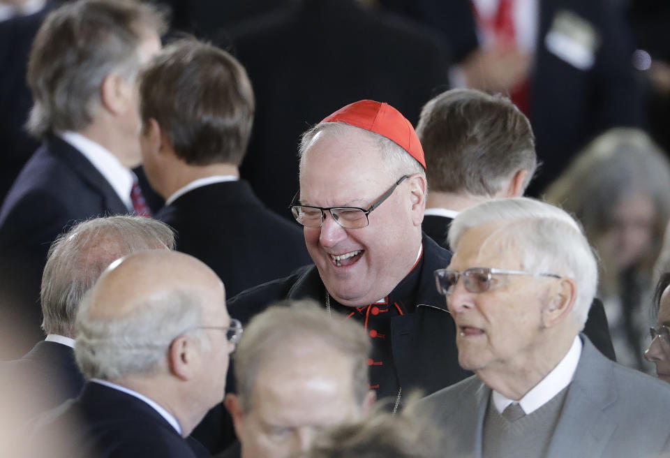 <p>Cardinal Timothy Michael Dolan, center speaks to mourners ahead of a funeral service at the Billy Graham Library for the Rev. Billy Graham, who died last week at age 99, Friday, March 2, 2018, in Charlotte, N.C. (Photo: Chuck Burton/AP) </p>