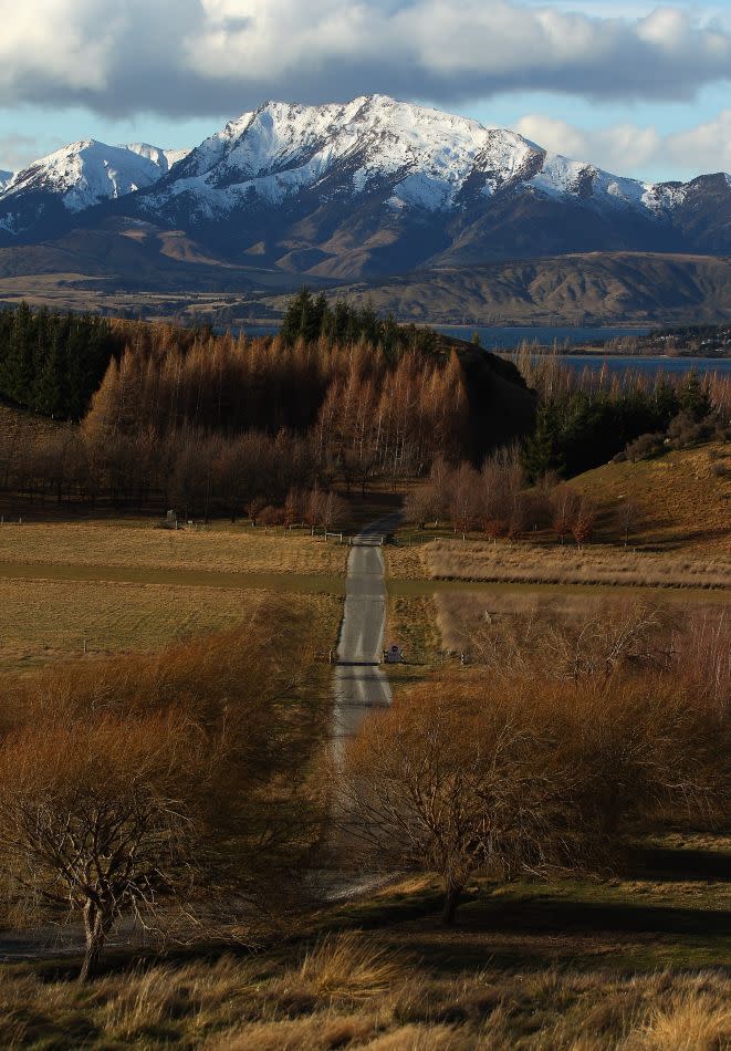 A road leads to a farm in Wanaka, New Zealand.