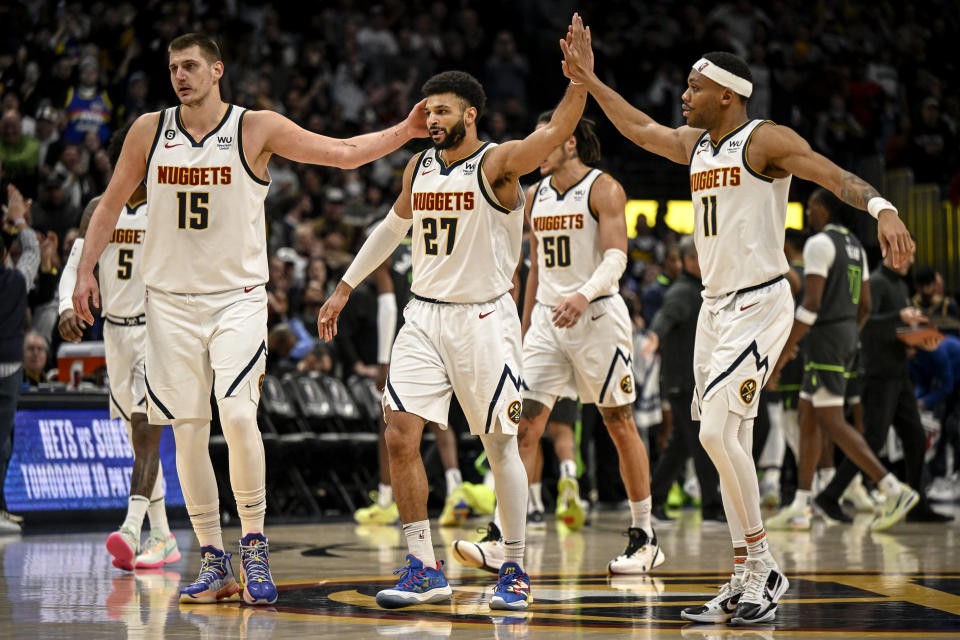 DENVER, CO - JANUARY 18: Nikola Jokic (15) and Bruce Brown (11) reacts to the clutch play of Jamal Murray (27) of the Denver Nuggets down the stretch against the Minnesota Timberwolves during the fourth quarter of the Nuggets 122-118 win at Ball Arena in Denver on Wednesday, January 18, 2023. (Photo by AAron Ontiveroz/The Denver Post)