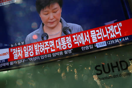 People watch a television broadcast of a news report on President Park Geun-hye releasing a statement to the public in Seoul, South Korea, November 29, 2016. REUTERS/Kim Hong-Ji