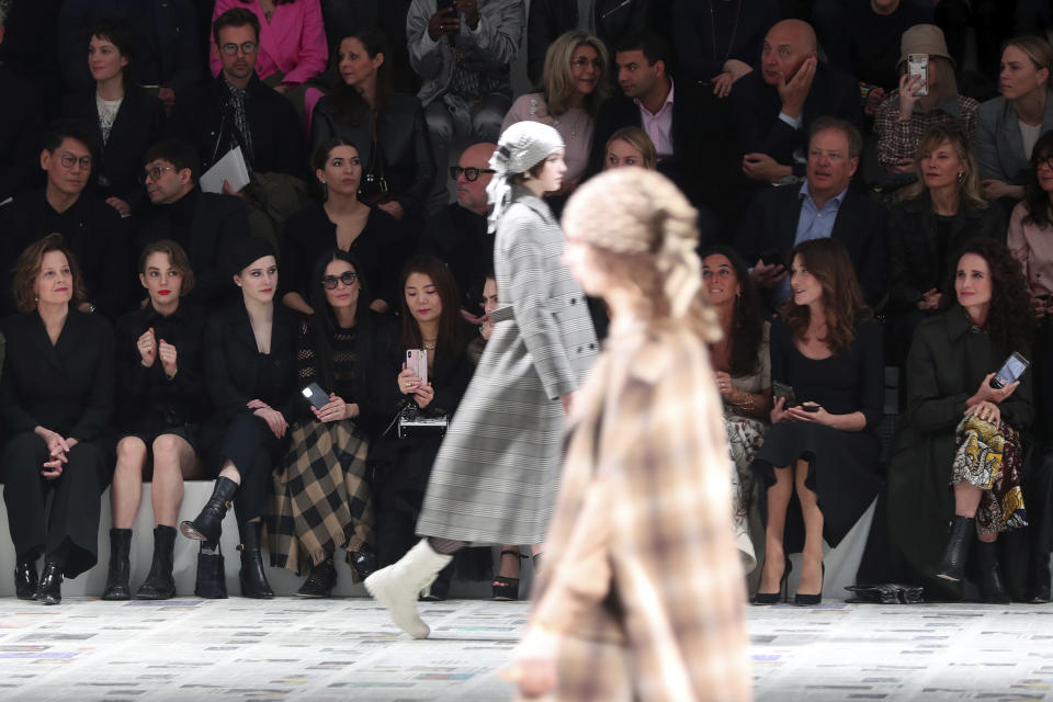 Sigourney Weaver, left, her daughter Charlotte, second from left, Rachel Brosnahan, third from left, Demi Moore, fourth from left, Carla Bruni, second from right, and Andie MacDowell, right, attend to the Dior fashion collection during Women's fashion week Fall/Winter 2020/21 presented in Paris, Tuesday, Feb. 25, 2020. (AP Photo/Thibault Camus)