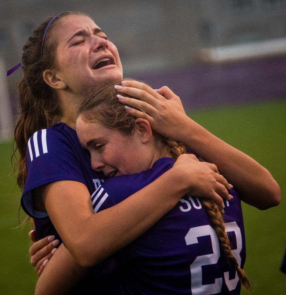 South's Izzy Sweet (25) and Katharine Lacy (23) embrace to celebrate South's victory after the girls IHSAA regional soccer final at Bloomington High School South on Saturday, Oct. 14, 2023.