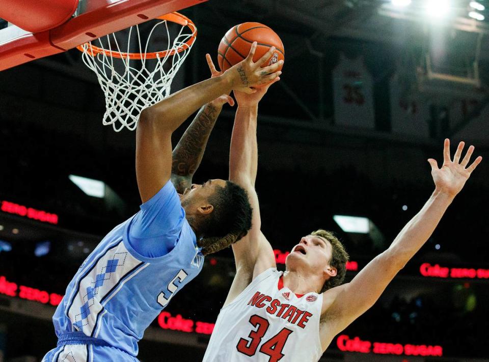 North Carolina’s Armando Bacot drives to the basket past N.C. State’s Ben Middlebrooks during the first half of the Wolfpack’s game at PNC Arena on Wednesday, Jan. 10, 2024, in Raleigh, N.C.