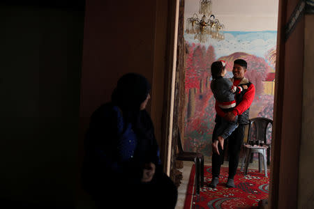 Palestinian Mustafa Sarhan, 19, a member of Gaza Skating Team, carries his sister as he plays with her at their family house in Gaza City March 18, 2019. REUTERS/Mohammed Salem