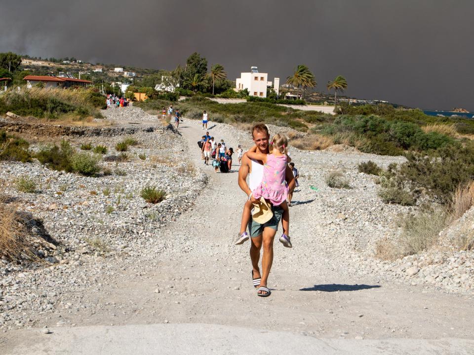 Tourists are evacuated as huge wildfire rages across Greece's Rhodes island on July 22, 2023.